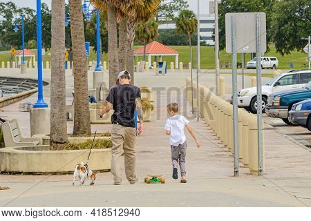 New Orleans, La - October 9: Two Boys And A Dog Walk Along Lake Pontchartrain On October 9, 2020 In 