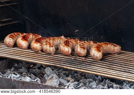 Delicious Grilled Sousages. Barbiquing Sousages On Hot Grill.