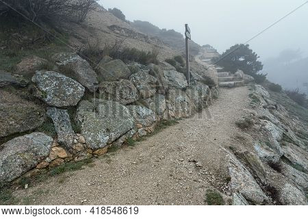Mountain Trail For Hiking On A Very Cold Day With Heavy Fog. Morcuera Madrid.