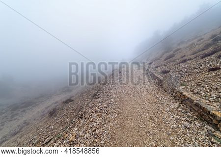 Stone Path In The Mountain On A Day Of Intense Fog And Atmosphere Of Mystery. Morcuera. Spain.