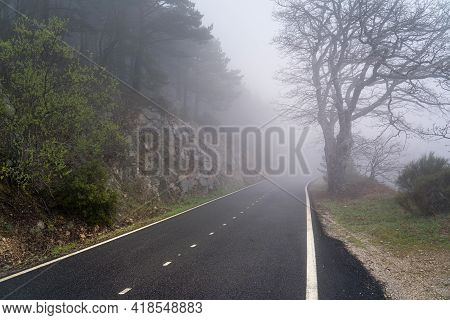 Straight Mountain Road On A Heavy Foggy Day With Very Low Visibility. Morcuera, Madrid. Spain.
