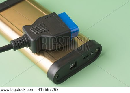 Car Diagnostic Scanner Obd2 On Mint Green Background. Equipment, Diagnostic Interface. Service, Repa