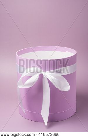 A Lilac Hatbox. Cylindrical Gift Box With A White Bow
