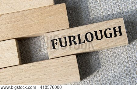 Furlough - Word On A Wooden Bar On A Gray Background. Business Concept