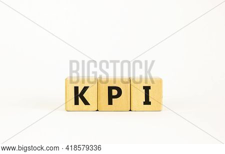 Kpi, Key Performance Indicator Symbol. Wooden Cubes With Word 'kpi, Key Performance Indicator' On Be