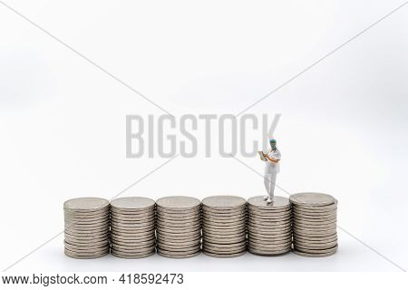 Business, Money Healthcare Concept. Docter Miniature Figure People Wearing Cap And Face Mask With Pa