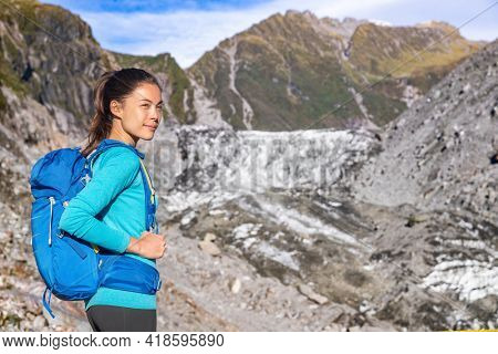 Travel adventure. Tourist explorer backpacking nature landscape by glacier. New Zealand tourists in nature landscape, Franz Josef Glacier, Westland Tai Poutini National Park, South Island New Zealand.