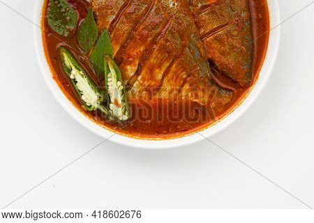 White Pomfret Masala Curry , Made In South Indian Style With Thick Red Gravy And Garnished With Gree