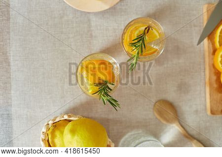Citrus And Rosemary Fresh Lemonade In Glass On A White Table At Home