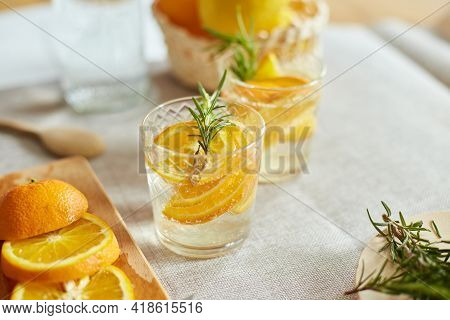 Citrus And Rosemary Fresh Lemonade In Glass On A White Table At Home