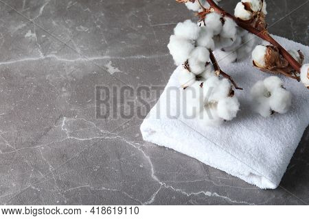 Cotton Plant Branches And Towel On Gray Textured Background