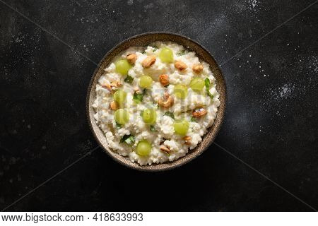 Curd Rice Withcashews, Grapes, Cilantro, Ginger On A Black Background. Indian Cuisine