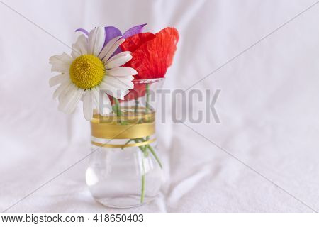 Bunch Of Beautiful Wildflowers In A Glass Vase On White Background.space For Text.