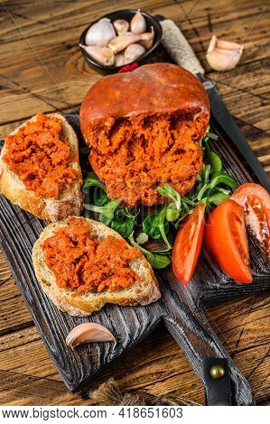 Tapaa Sandwichs With Sobrassada Cured Pork Meat Sausage And Tomato On A Wooden Cutting Board. Wooden