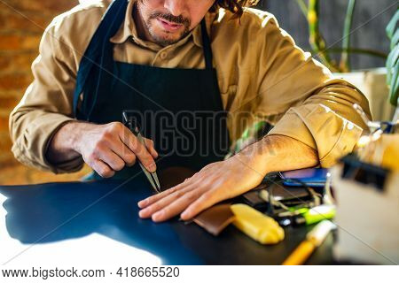 Hobby Became A Small Business Leather Man In Apron Is Making A Leather Wallet And Shooes In Studio