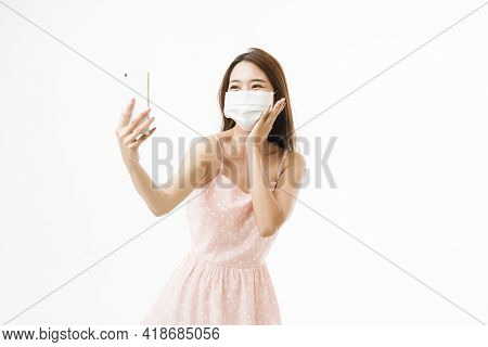 Asian Woman Taking Self Portrait By Smartphone With Smile While Wearing Protective Face Mask, Optimi