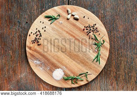 Empty Cutting Wood Board, On Which Peppercorns Are Laid, Garlic With Slices, Rosemary Fresh And Sava
