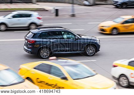 Moscow , Russia - April 2021: Side View Rolling Shot With Black Car In Motion. Bmw X5 M Crossover Dr
