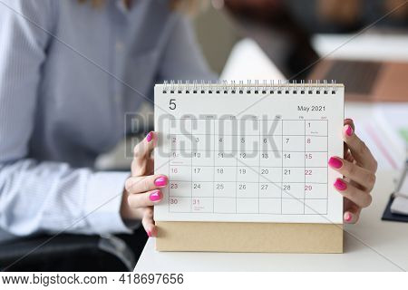 Female Hands With Pink Manicure Holding Looseleaf Paper Calendar Closeup