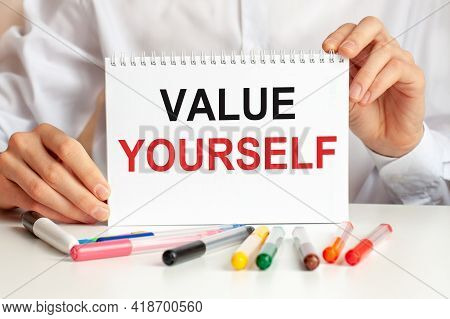 A Hand Holds A Sign With The Inscription - Value Yourself, Finance And Economics Concept