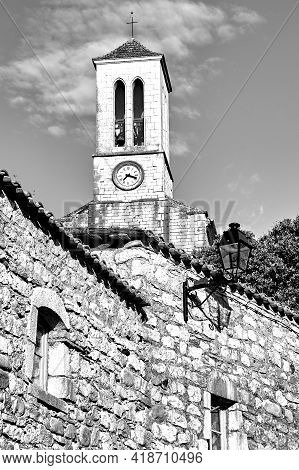 Stone Houses And Belfry With Clock In Village Of Balazuc In France, Monochrome