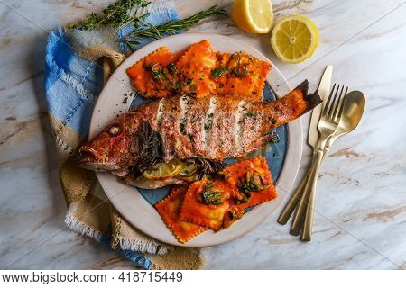 Whole Head-on Red Snapper Seafood Dinner With Ravioli In Sherry Wine Pink Sauce