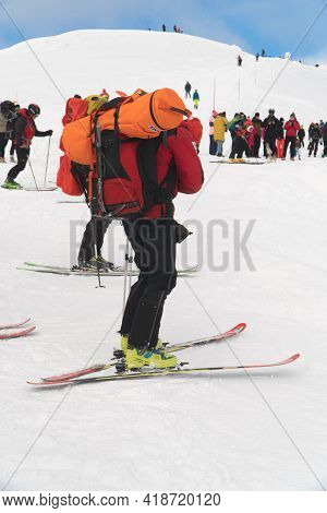 Kasprowy Wierch, Poland 28.01.2021 - Back View Of Mountain Rescue Team Topr Wearing Backpacks. A Bun