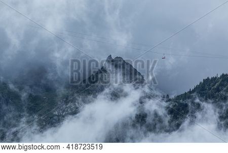 Mountains In The Mist And Gondola Going Through