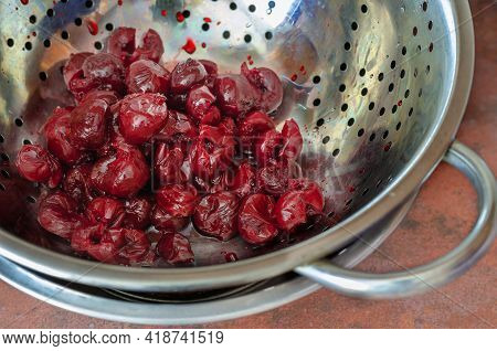 Fresh Thawed Seedless Cherries In A Metal Colander. Close-up Of Ripe Berries Ready To Eat. Berries F