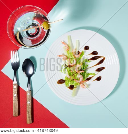 Fresh Summer Salad Of Shrimps, Greens, Celery, Teriyaki Sauce With Cutlery, With Martini Glass On Re
