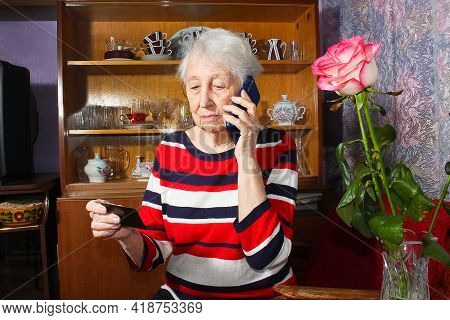 Senior Woman With Face Mask Making Reservation Online From Home And Paying With Credit Card.