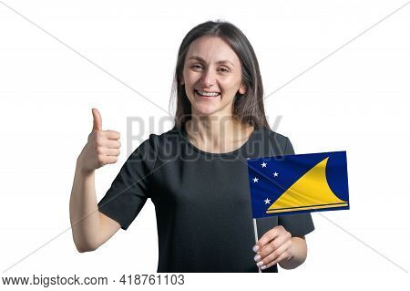 Happy Young White Woman Holding Flag Of Tokelau And Shows The Class By Hand Isolated On A White Back