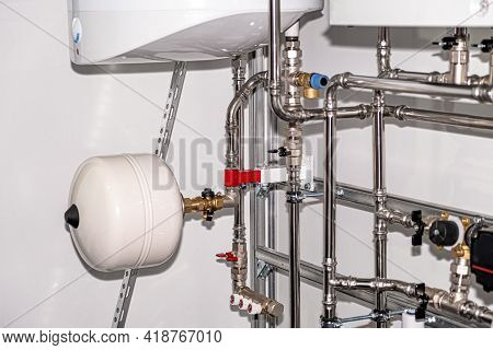 Plumbing Services. Stainless Steel Piping Of The Heating System In The Boiler Room. Heating Thermore