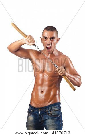 Mand i kampsport koncept med nunchucks
