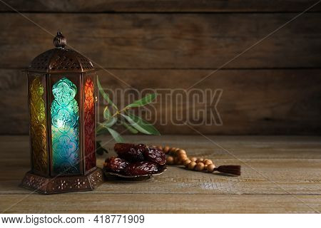Arabic Lantern, Dates And Misbaha On Wooden Table. Space For Text
