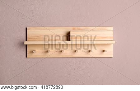 Wooden Hanger For Keys On Color Wall