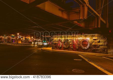 NORWALK, CT, USA - APRIL 24, 2021: SONO sign under railroad bridge on Washington Street  with evening lights