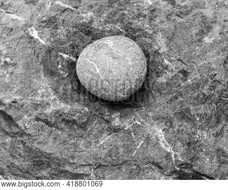 Round Stone - A Large Sea Pebble Lies In A Recess Of The Rock