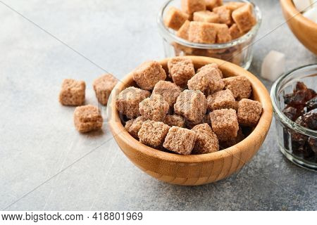 Cane Sugar Cube In Bamboo Bowl On Gray Table Concrete Background. Top View.
