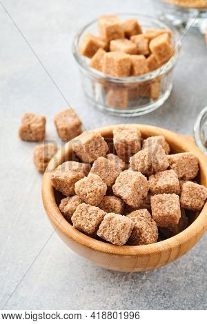 Cane Sugar Cube In Bamboo Bowl On Gray Table Concrete Background. Top View.