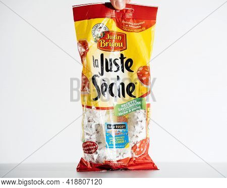 Paris, France - Jul 30, 2017: Male Fingers Holding Package With Justin Bridou La Juste Seche Delicio