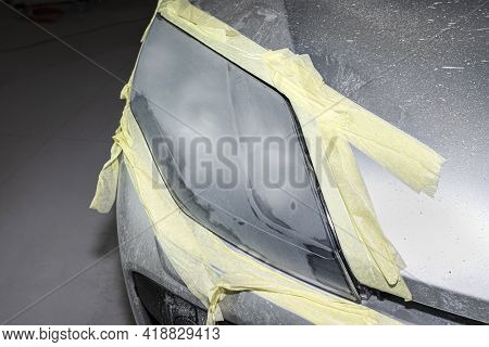 The Headlight Is Covered With Abrasive Paste And Secured With A Protective Tape, Prepared For Polish