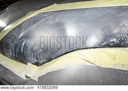 The Headlight Is Covered With Abrasive Paste And Secured With A Protective Tape, Prepared For Polish
