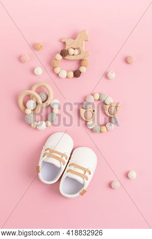 Baby Shoes And Teethers On Pink Background. Organic Newborn Fashion, Branding, Small Business Idea