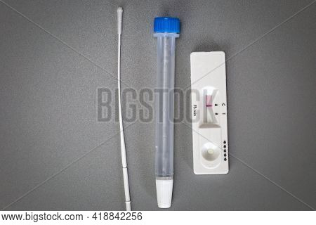 Rapid Self Test Covid-19 With Nose Swab, Home Test Kit For Coronavirus Top View On Gray Background W