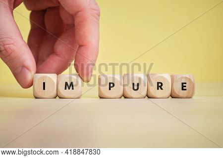 Concept Pure And Impure On Wooden Cubes