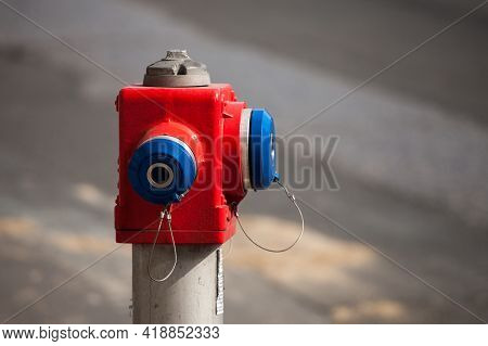 Selective Blur On A Red And Blue Fire Hydrant From The Serbian Firefighters, In A Street. It Is Used