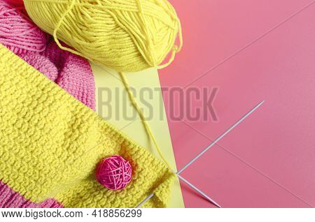 A Skein Of Bright Yellow Yarn With Spokes On A Colored Background. Needlework Against The Background