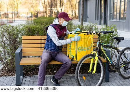 Kiev, Ukraine - April 28, 2021: Glovo Bike Courier On The Street. Delivery Boy Of Glovo Delivery Ser