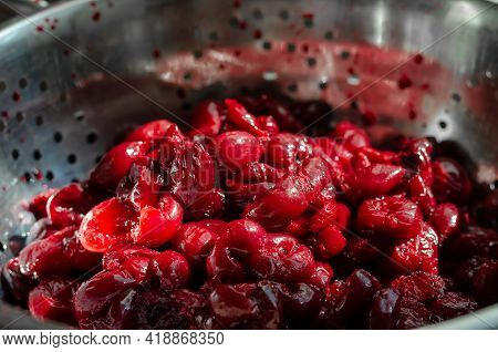 Fresh Thawed Seedless Cherries In A Metal Colander. Close-up Of Ripe Berries Ready To Eat. Berries F